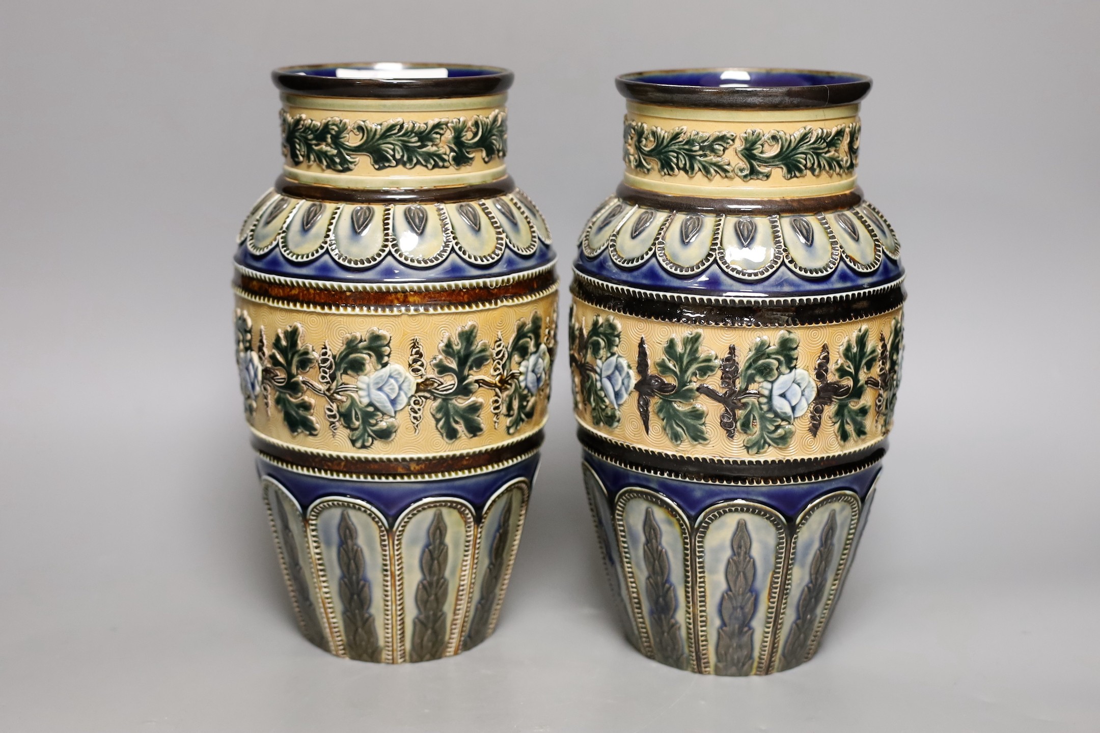 A pair of Doulton Lambeth vases, c.1885, 25.5cms high (a.f.)